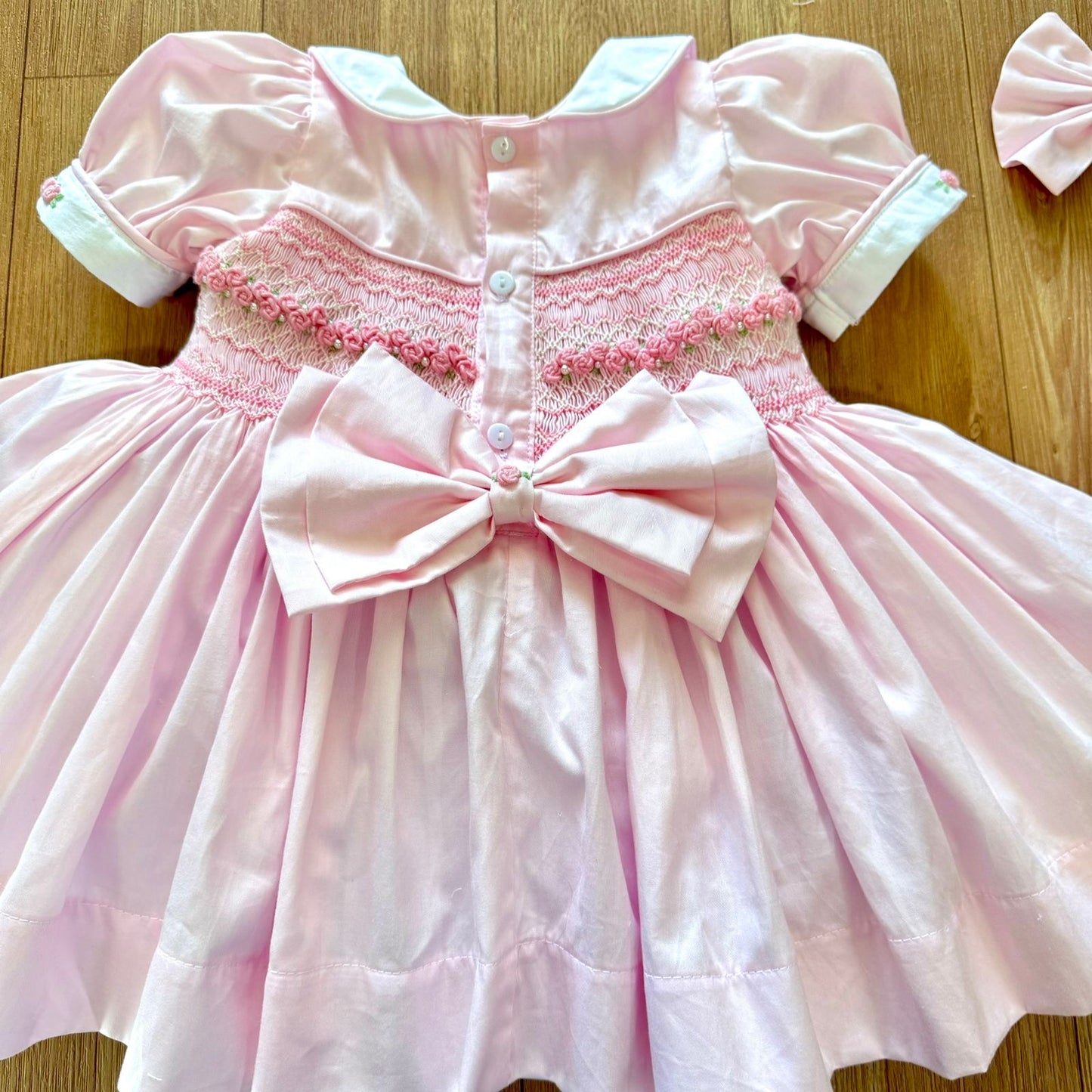 Pink smocked back and front with roses and pearls