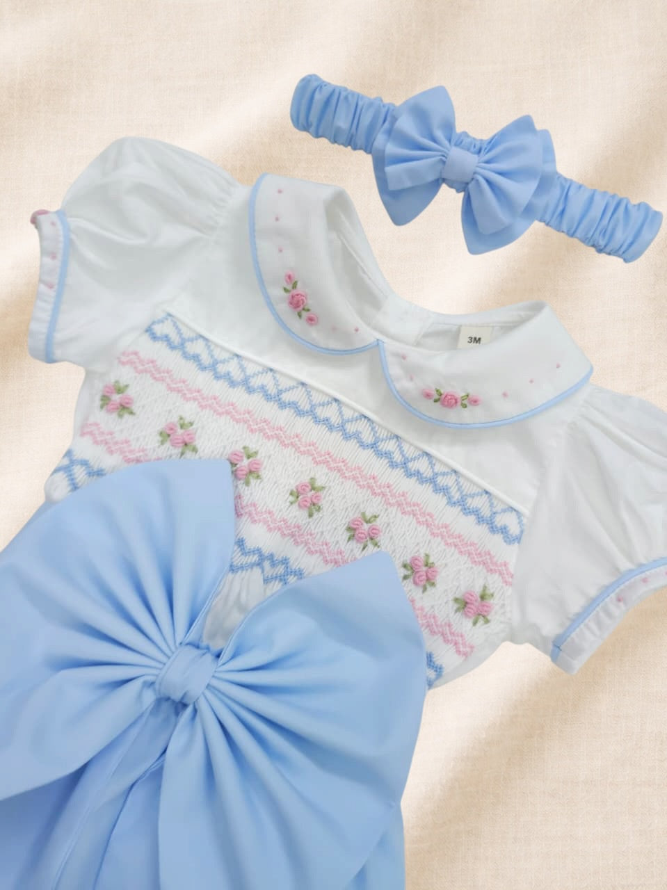 Baby blue hand smocked girls romper