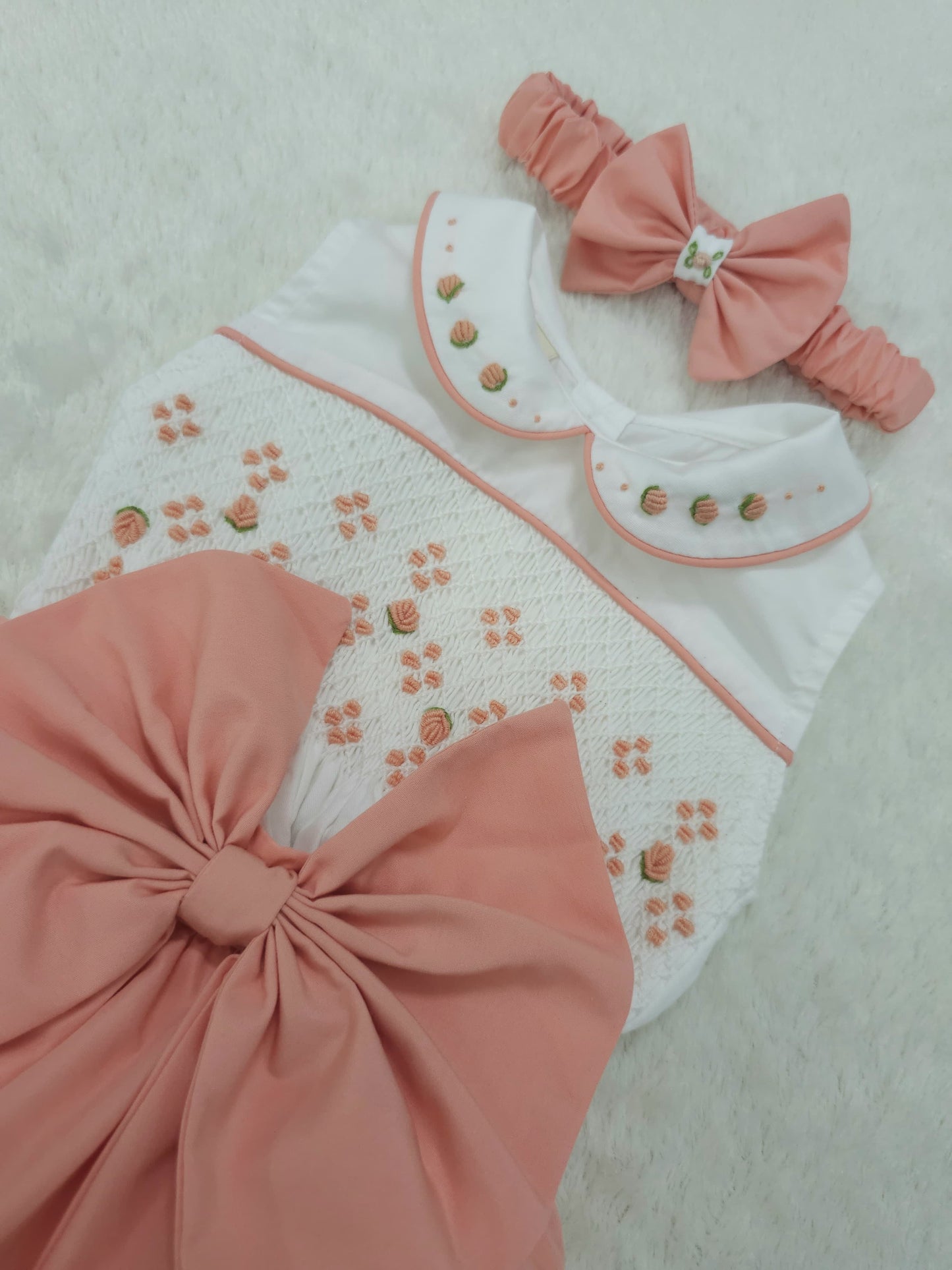 Coral sleeveless smocked romper