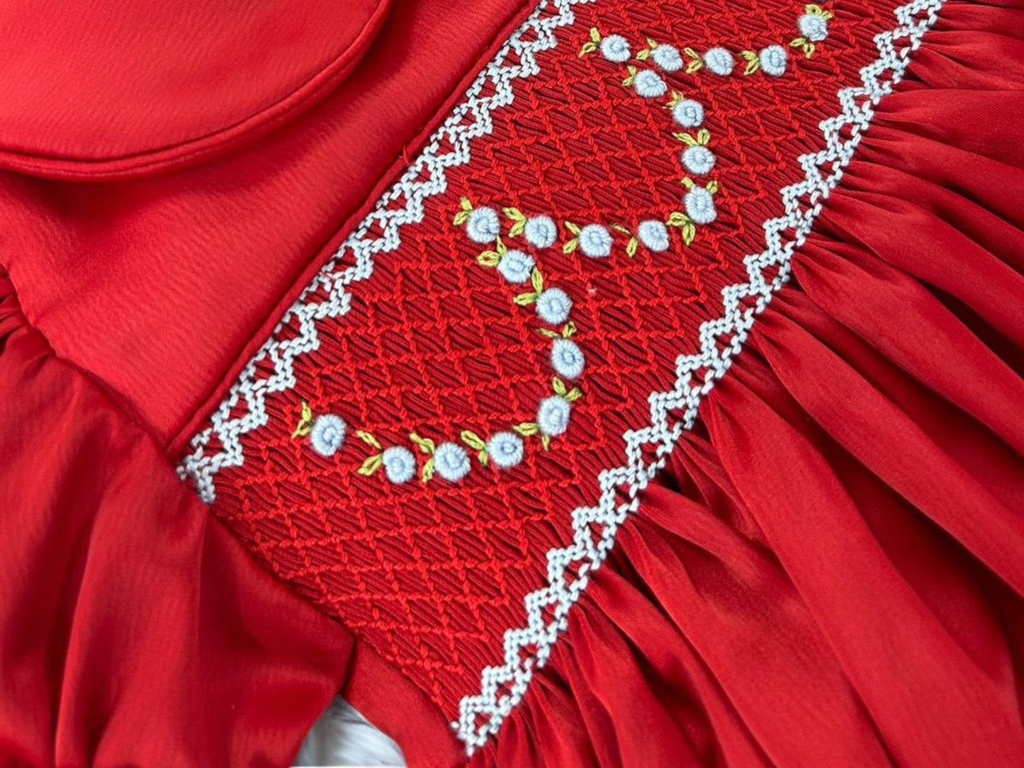 Red satin hand smocked pyjamas with blue garland