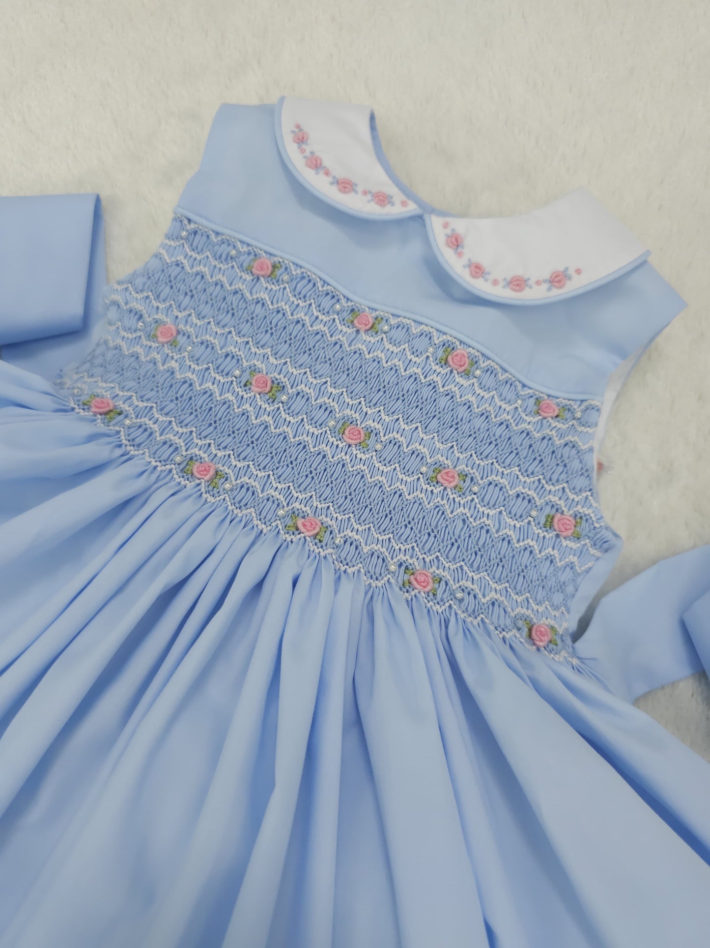 Baby blue smocked sleeveless with pink embroidered roses and pearls