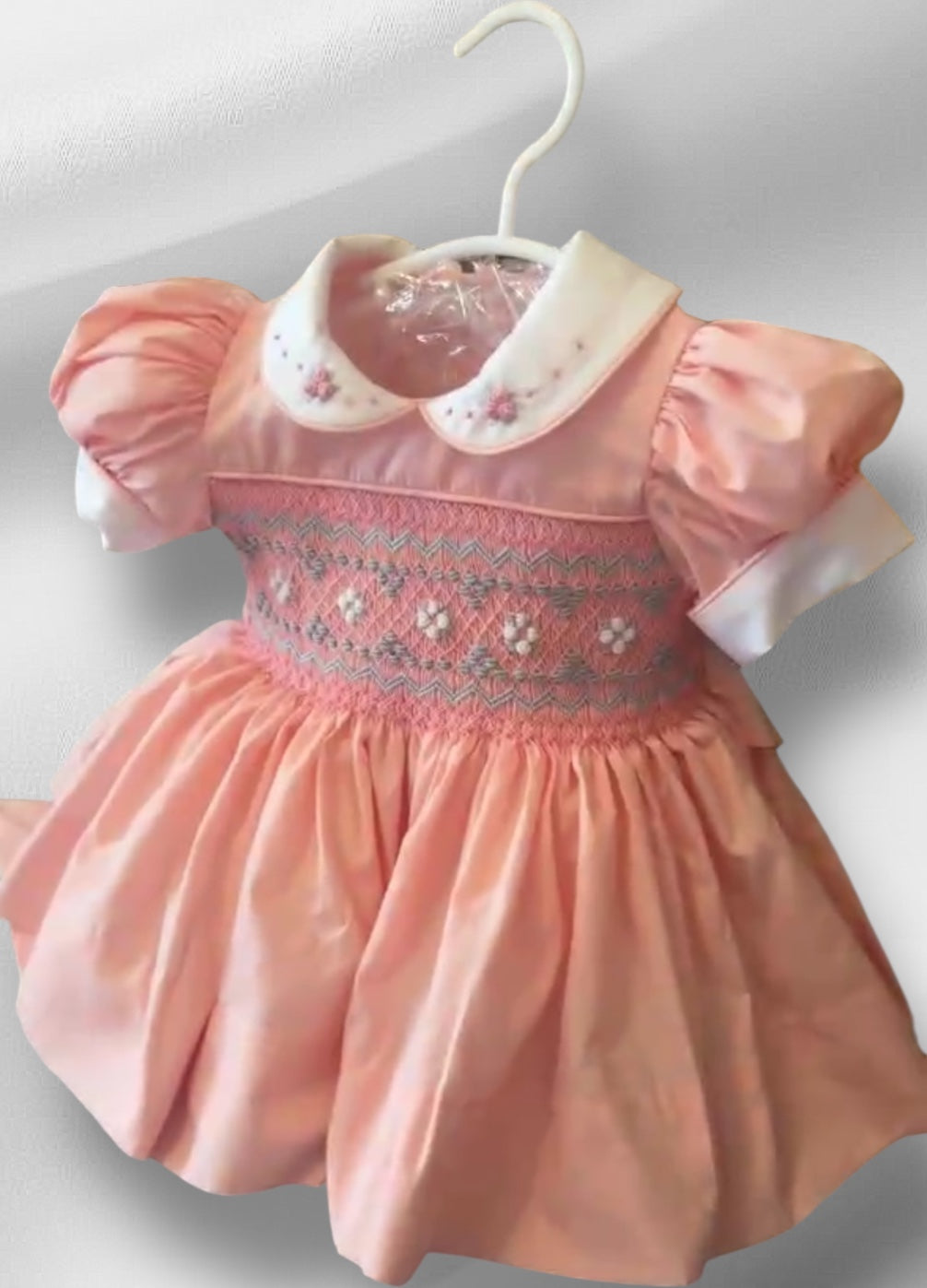 Peach coral smocked back and front with blue and white smocking