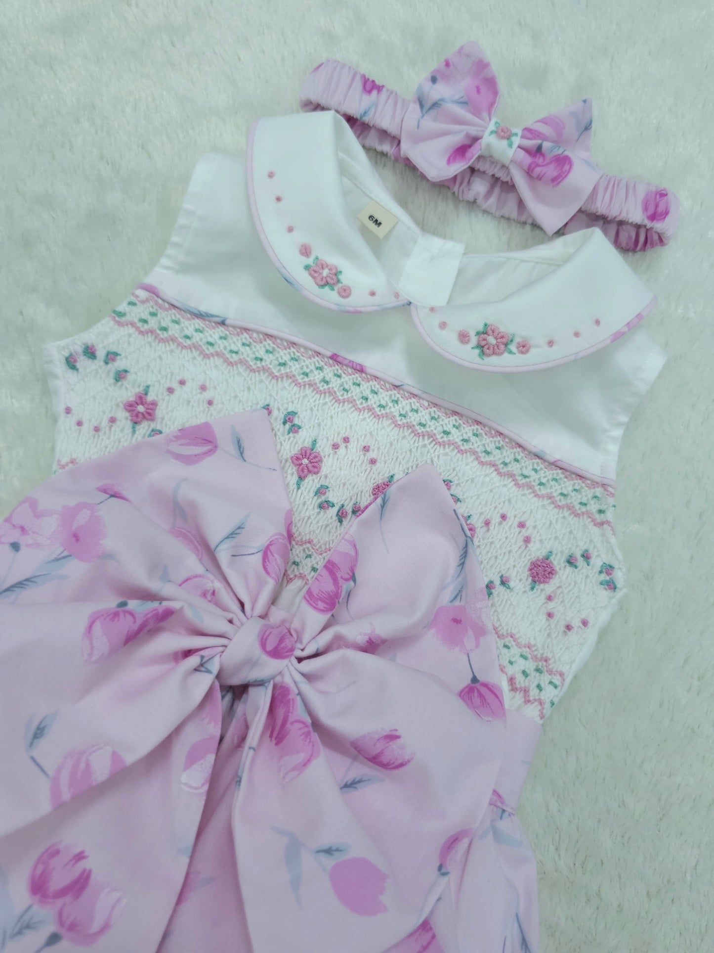 Pink floral sleeveless smocked romper