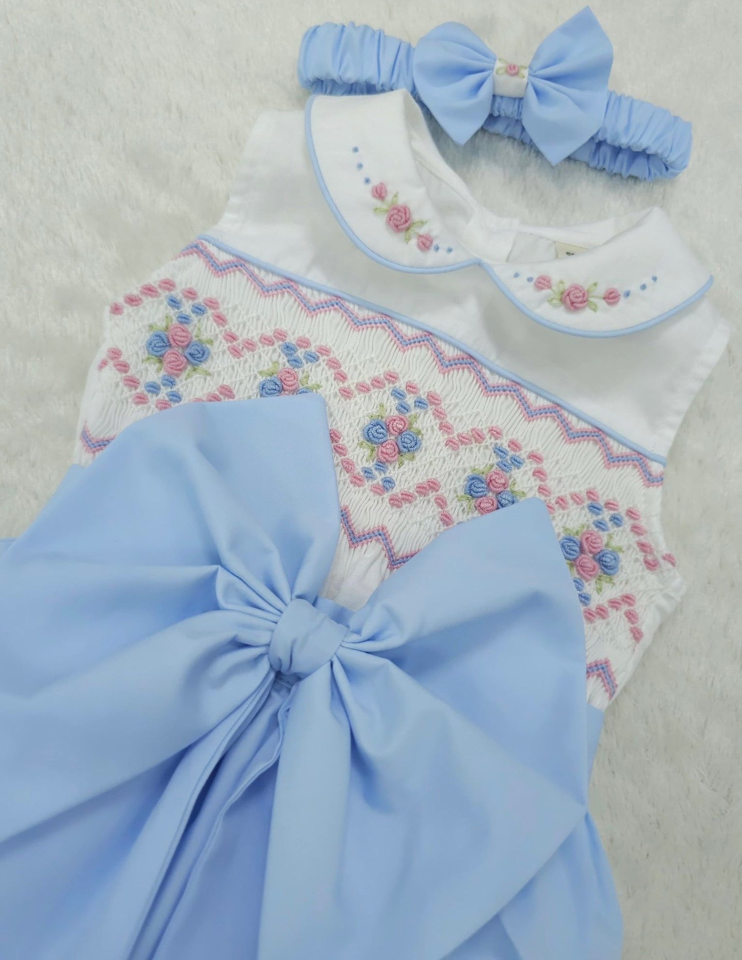 Baby blue smocked sleeveless romper