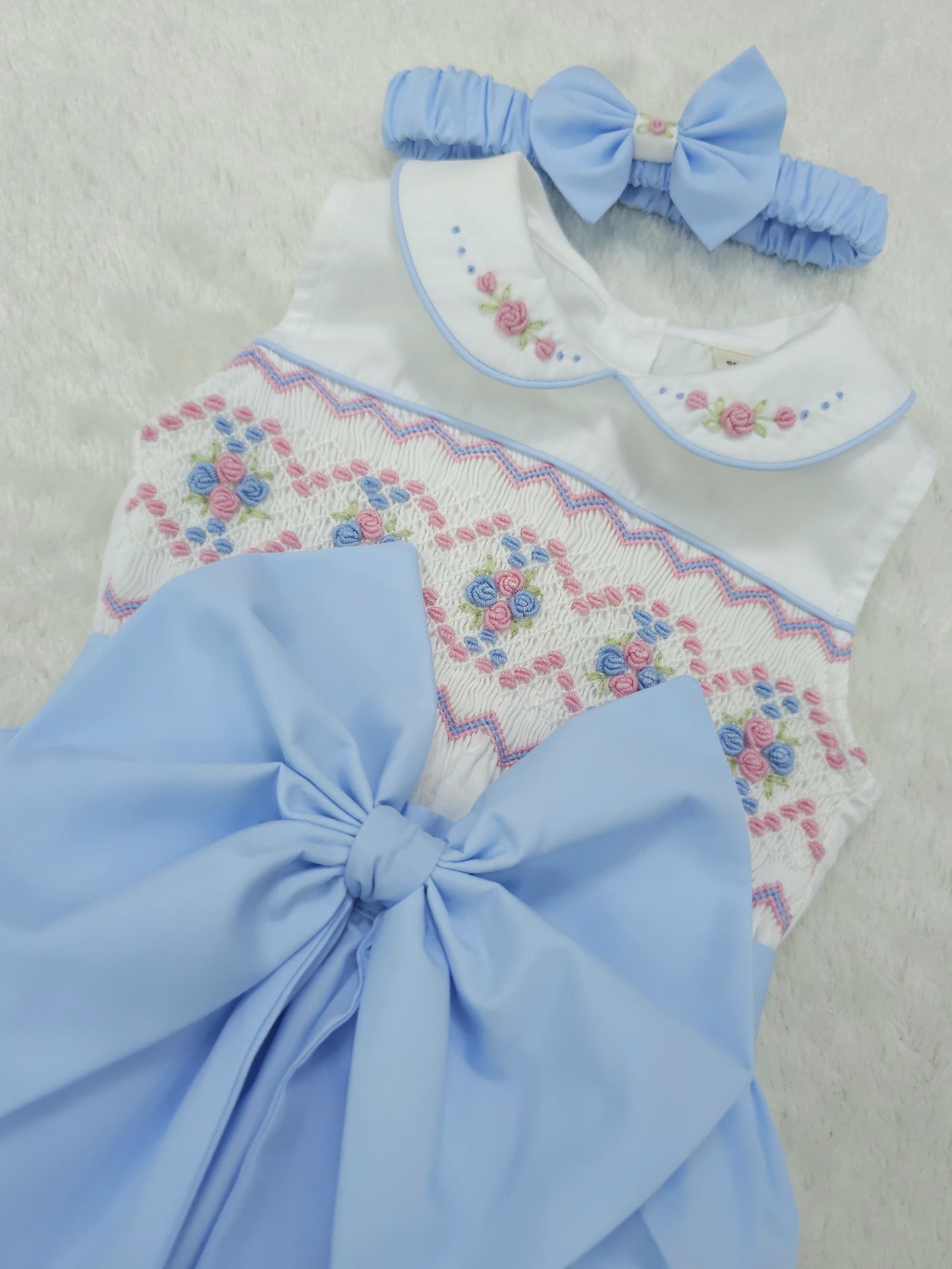 Baby blue smocked sleeveless romper