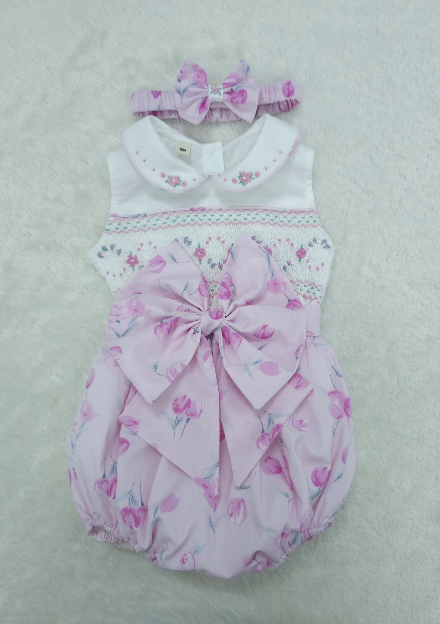 Pink floral sleeveless smocked romper