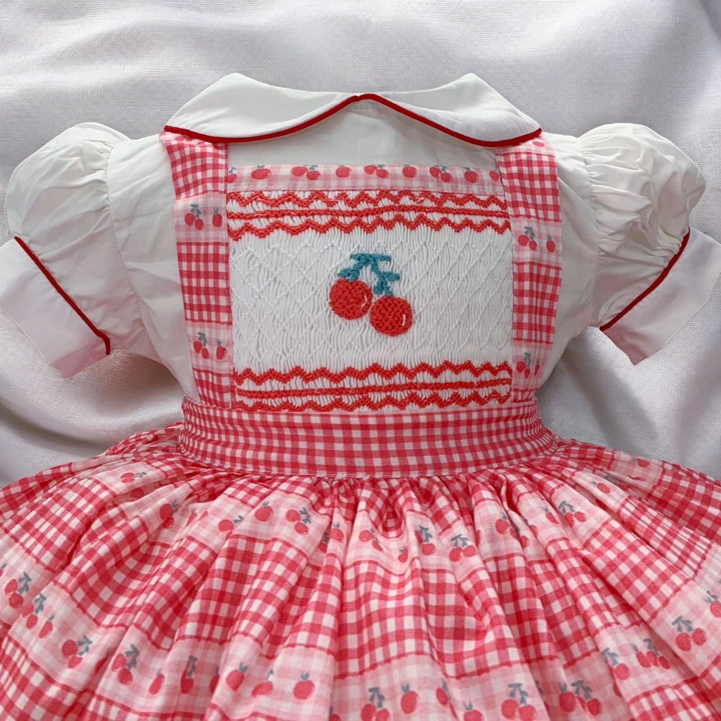 Cherry smocked pinafore dress