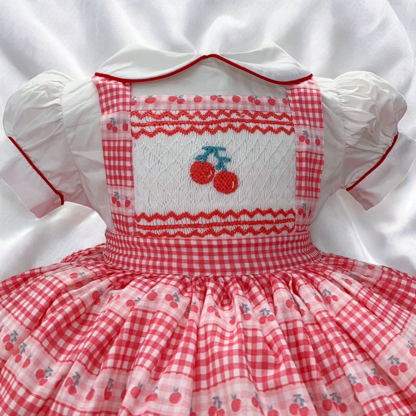 Cherry smocked pinafore dress