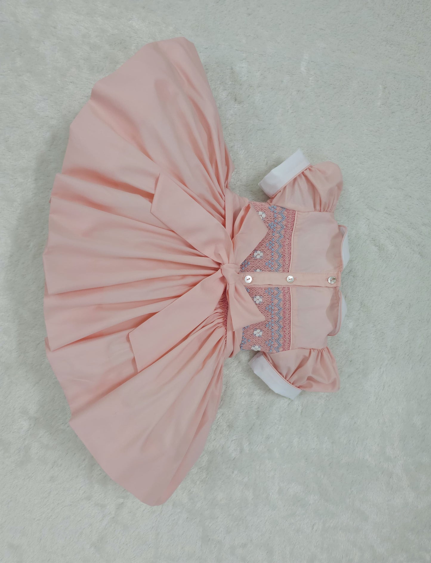 Peach coral smocked back and front with blue and white smocking