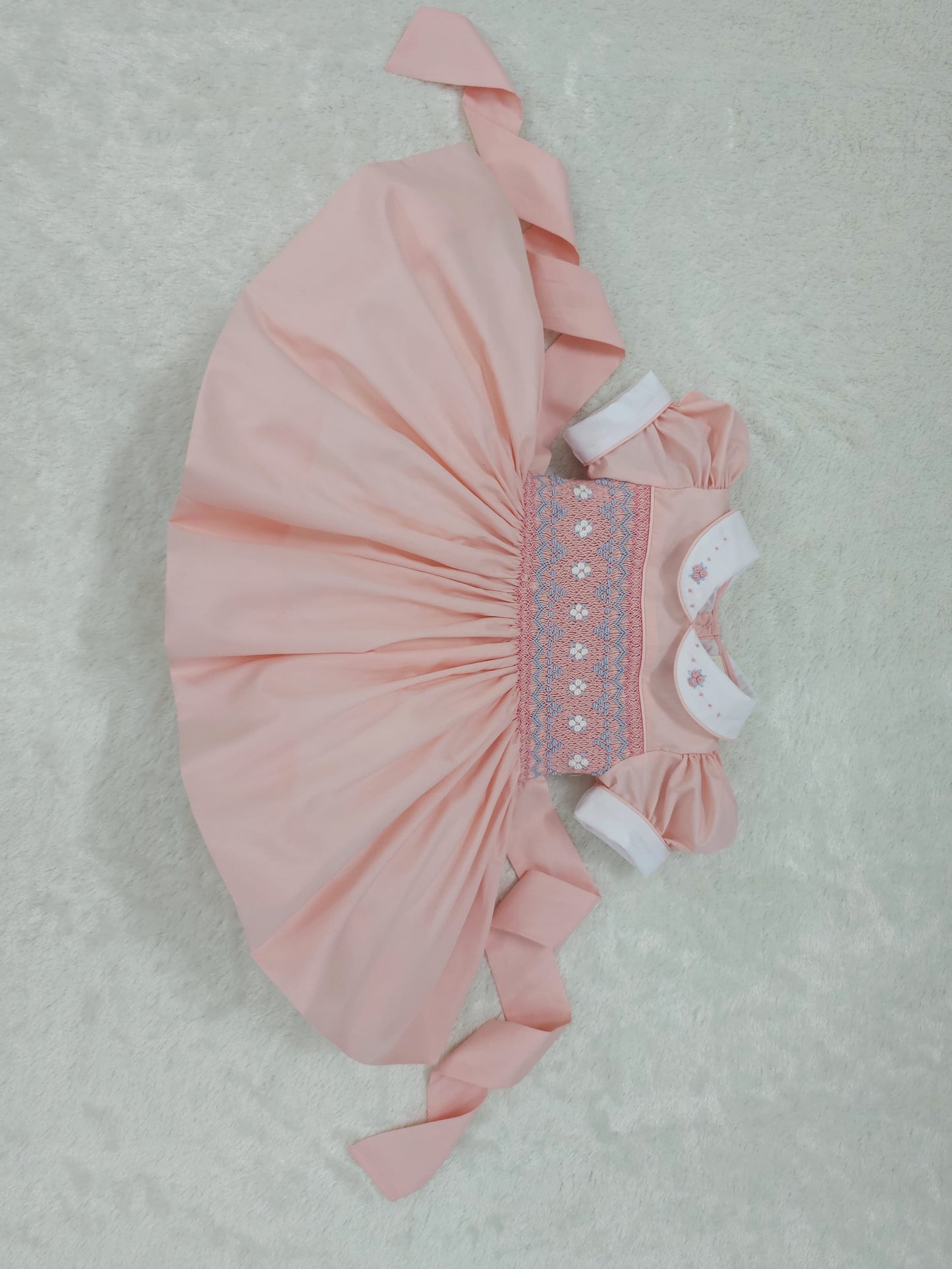 Peach coral smocked back and front with blue and white smocking