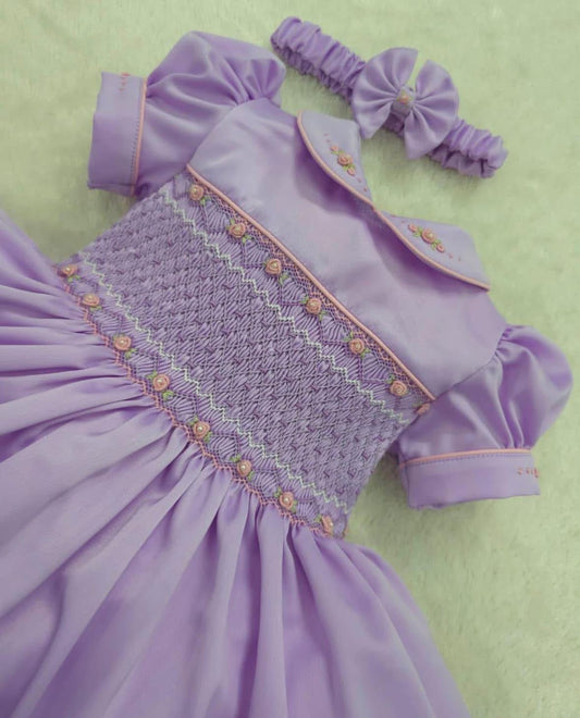 Lilac smocked dress fitted thick petticoat and comes with matching hair bows or headband for baby sizes