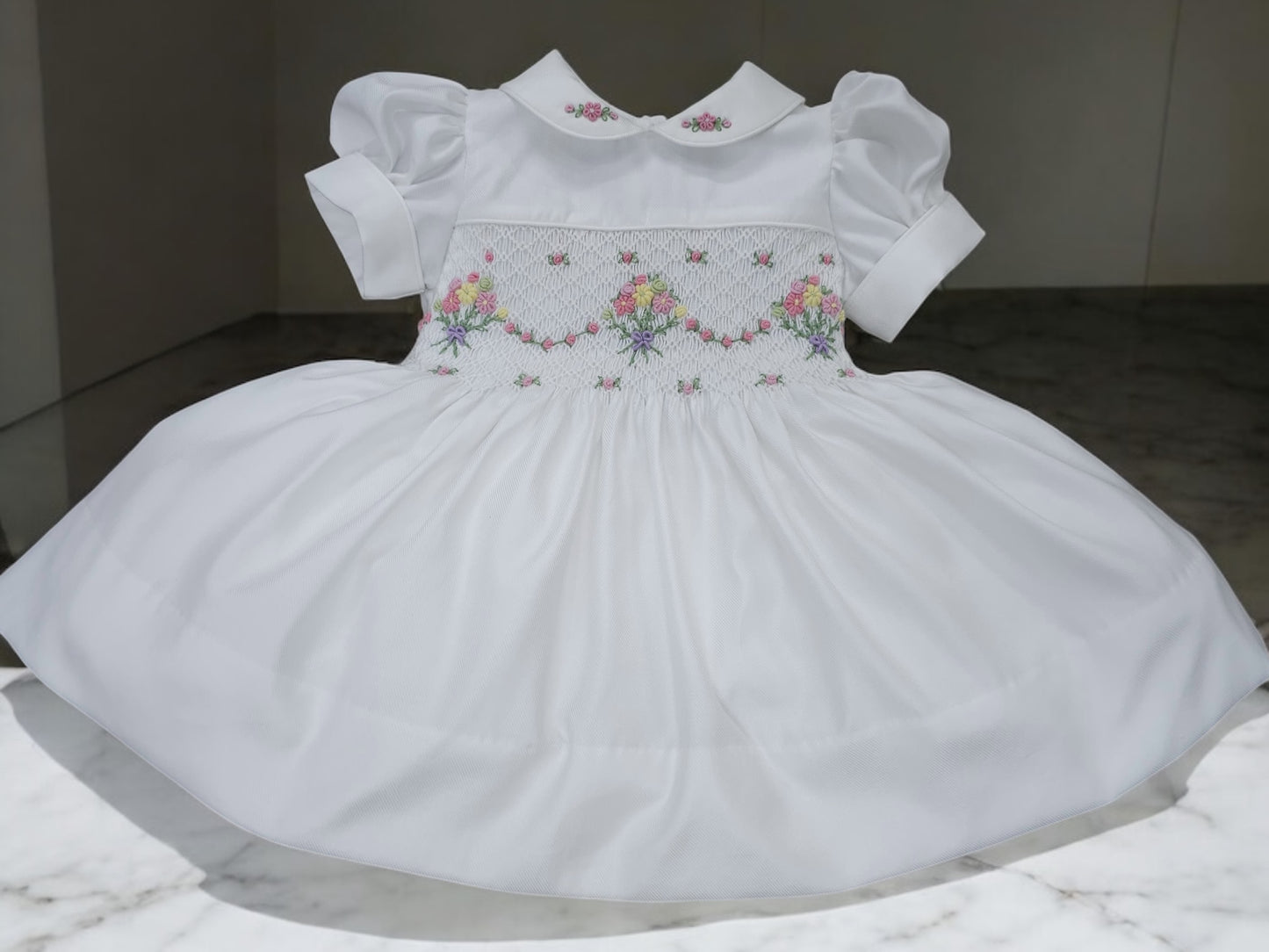 White smocked dress with embroidered flower baskets