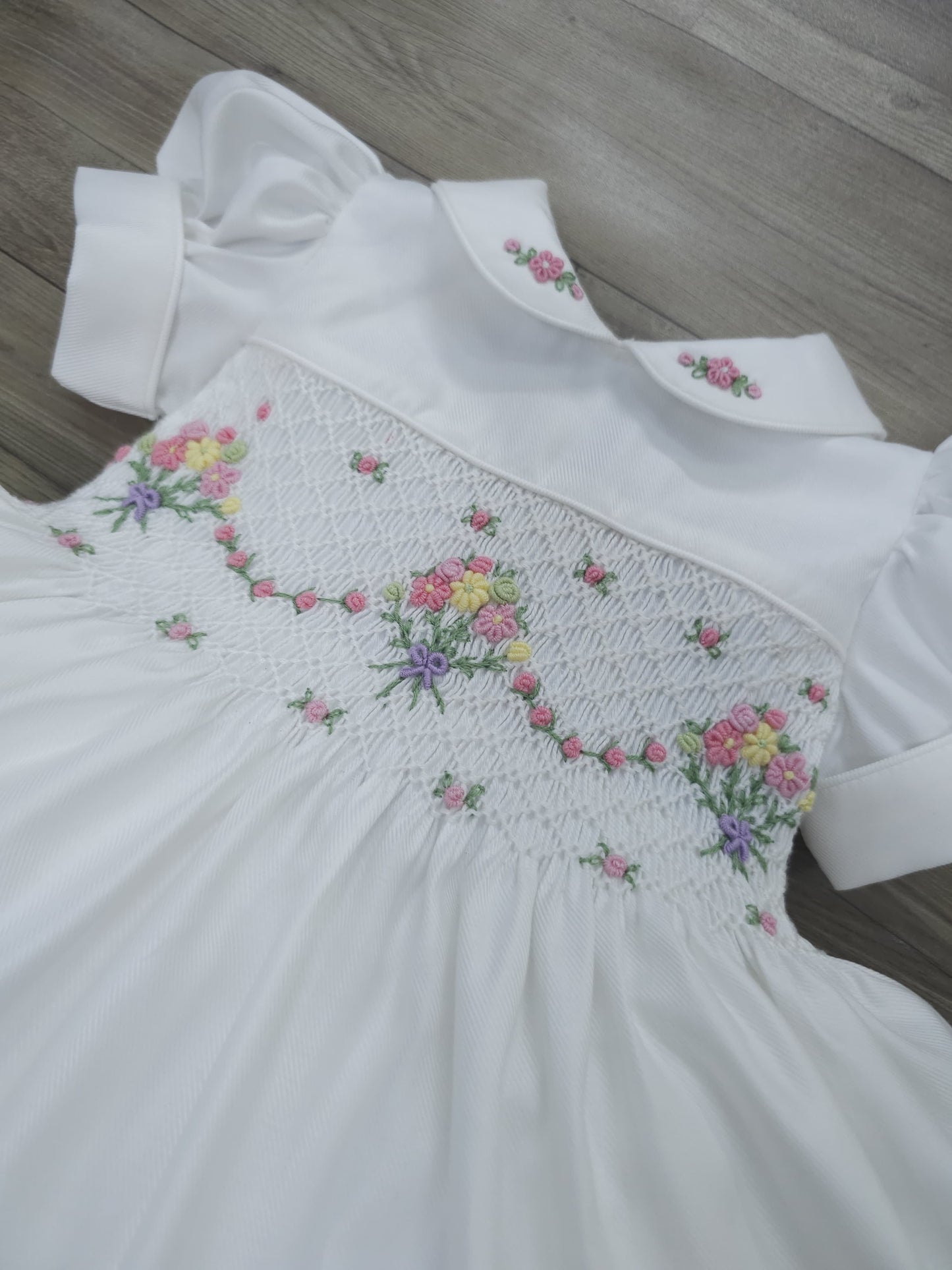 White smocked dress with embroidered flower baskets