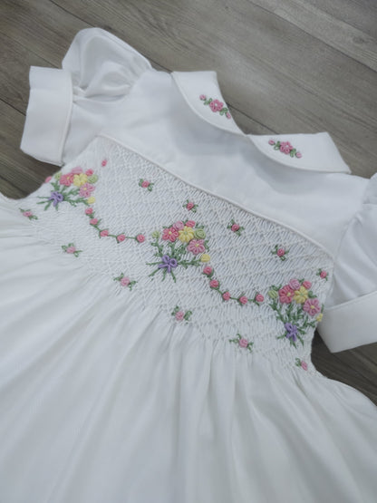 White smocked dress with embroidered flower baskets