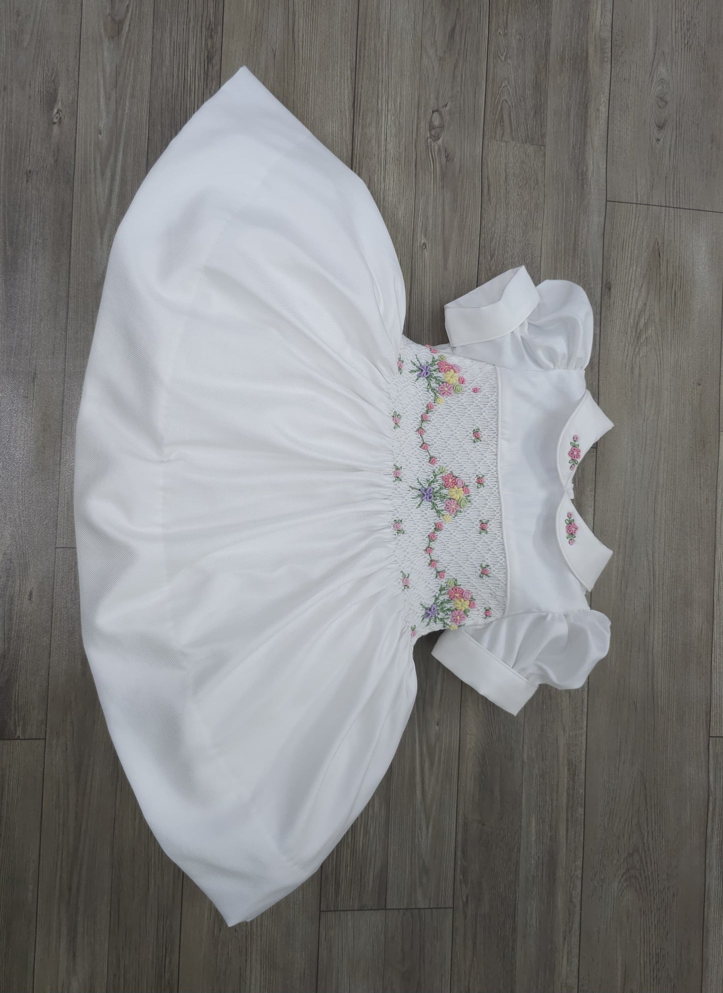 White smocked dress with embroidered flower baskets