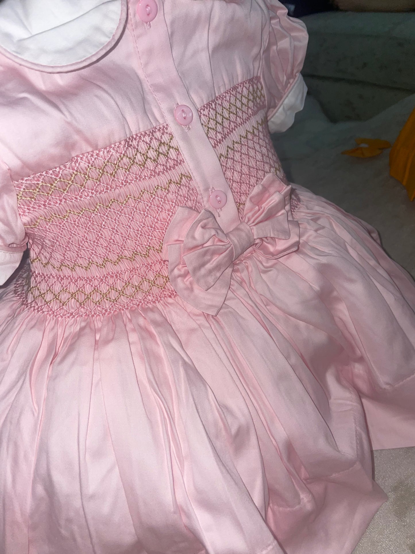 Pink with gold. Smocked back and front