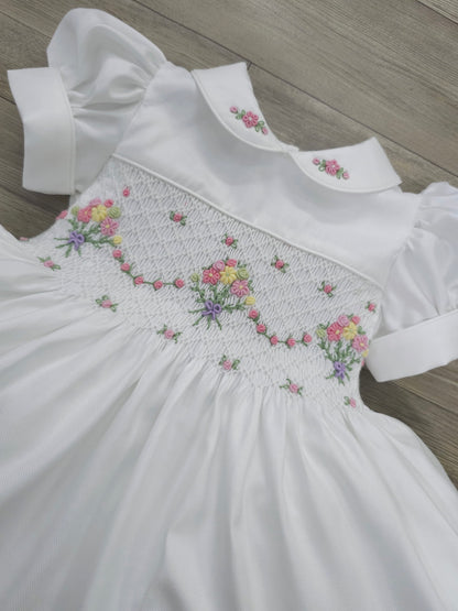White smocked dress with embroidered flower baskets