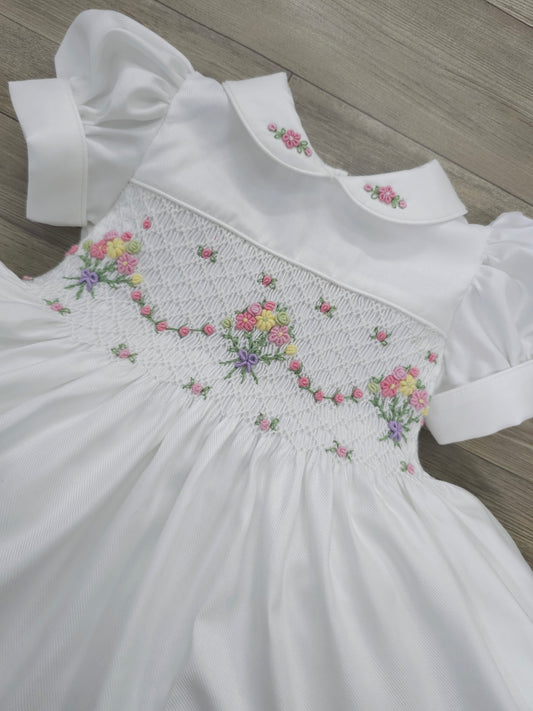 White smocked dress with embroidered flower baskets