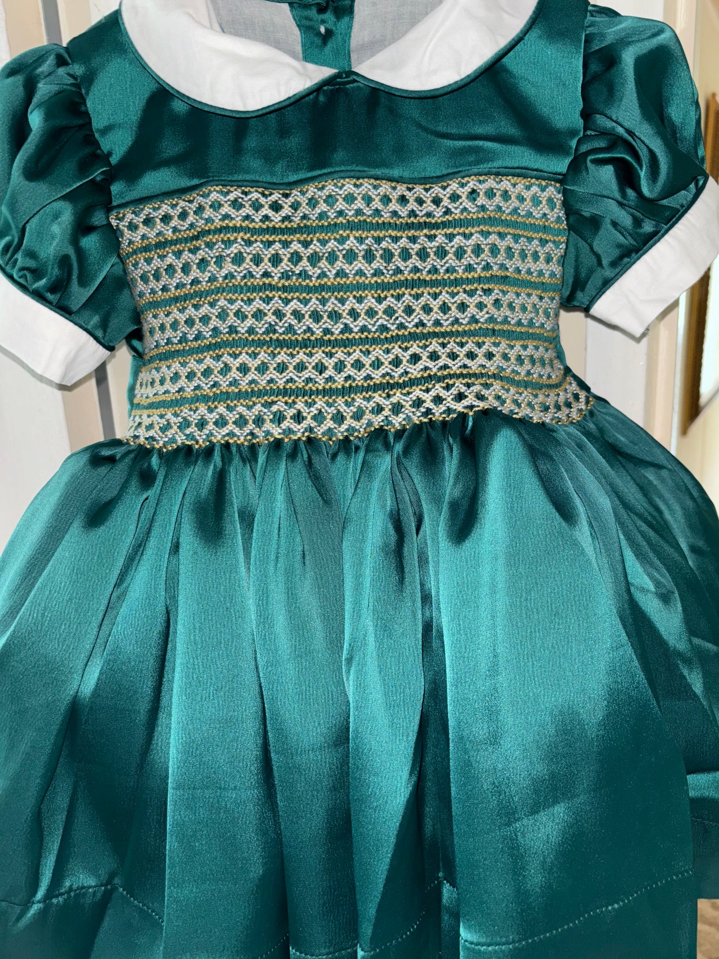 Emerald green satin with gold smocking