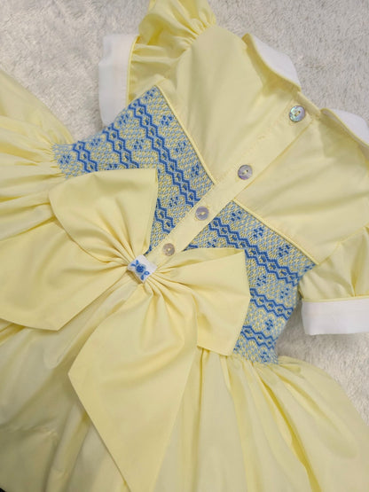 Lemon with blue smocked back and front with fixed bow. ( have matching boys suit available )