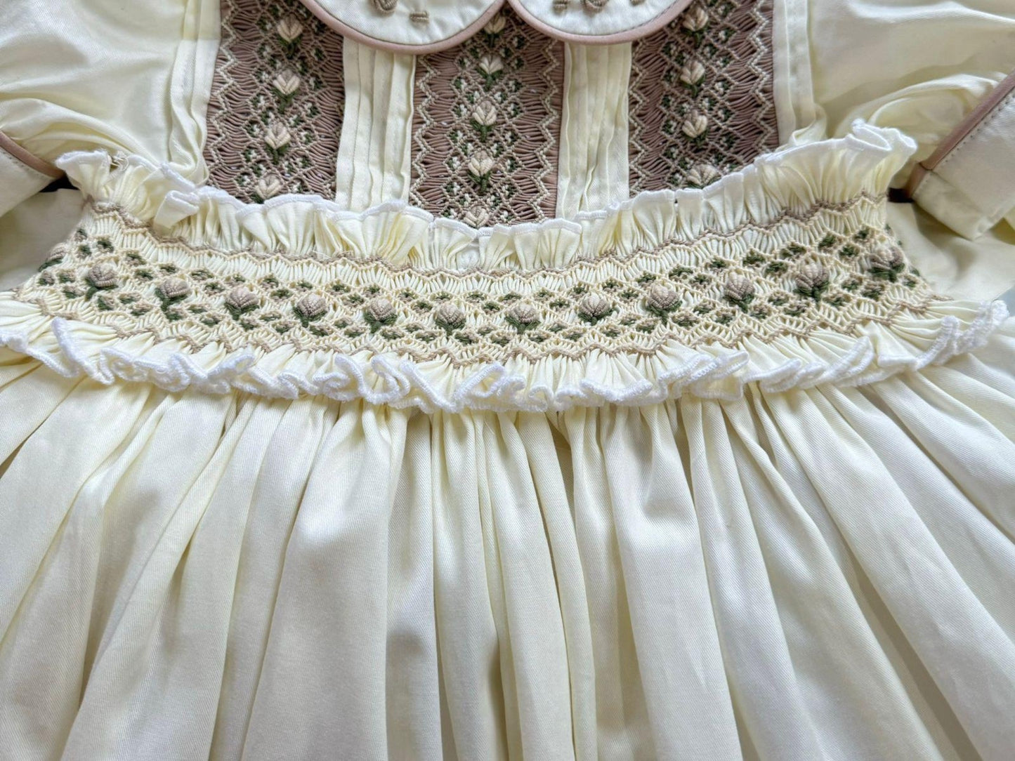 Cream dress with smocking on chest and waistband