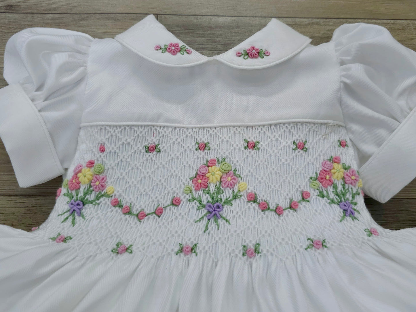 White smocked dress with embroidered flower baskets