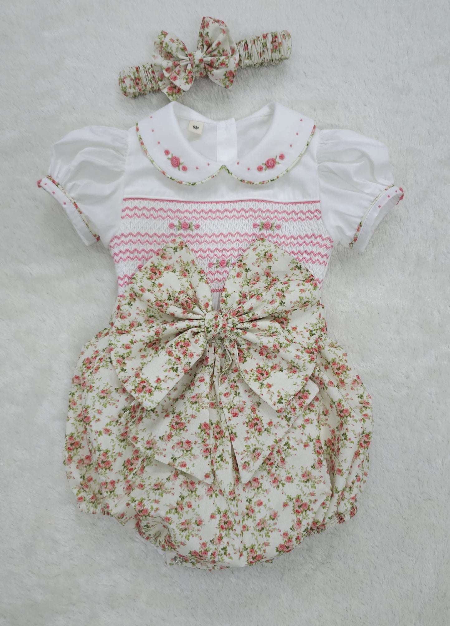 Pink floral hand smocked girls romper