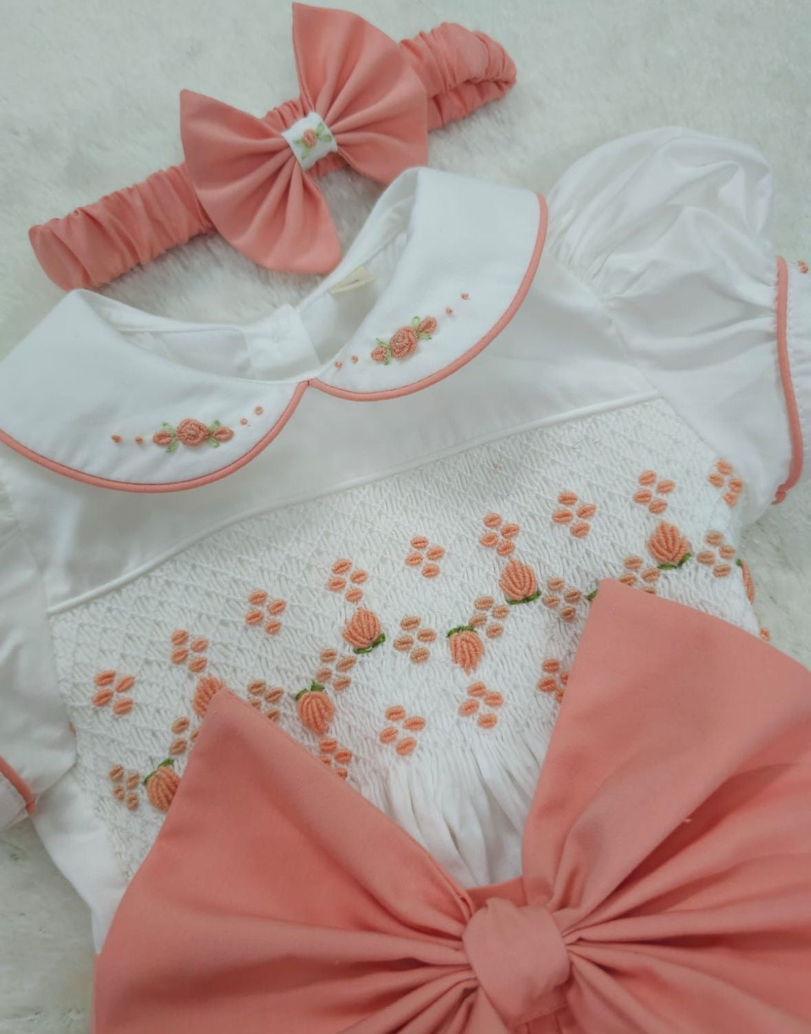 Coral peach smocked romper comes with hair bows or headband for baby sizes