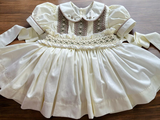 Cream dress with smocking on chest and waistband
