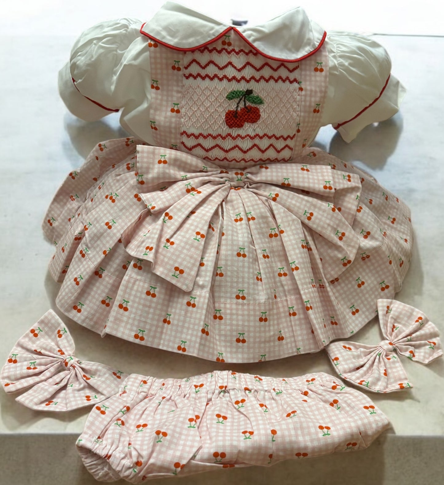 Cherry pinafore comes with knickers and bows