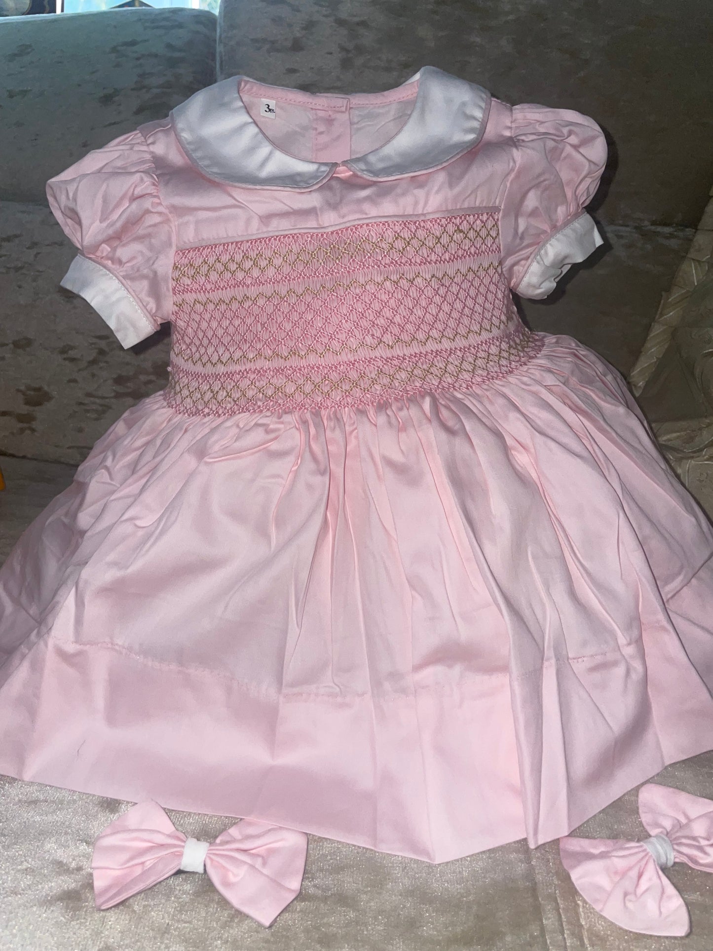 Pink with gold. Smocked back and front