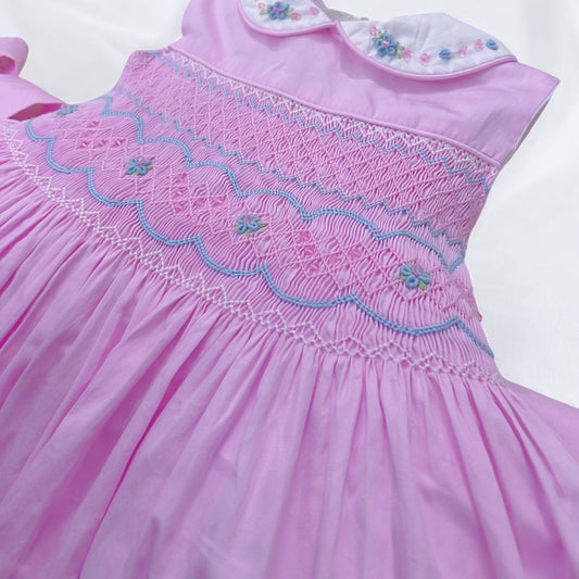 Pink sleeveless with blue embroidery and bead detail on collar
