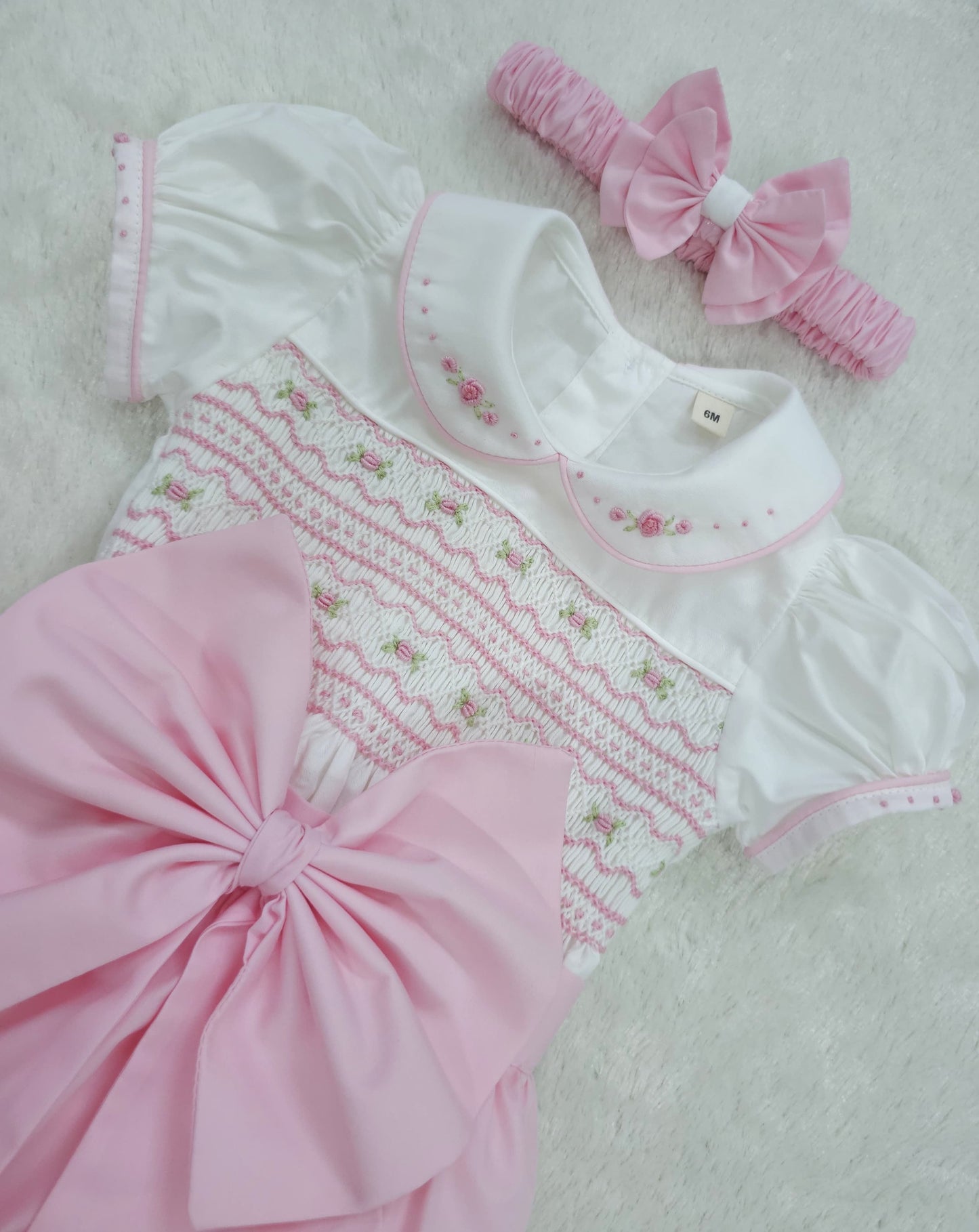 Baby pink hand smocked girls romper