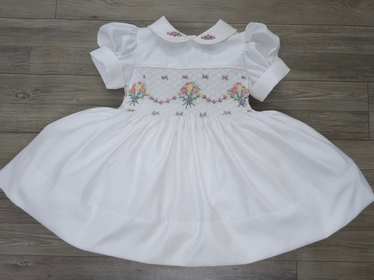 White smocked dress with embroidered flower baskets