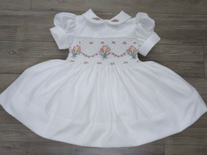 White smocked dress with embroidered flower baskets