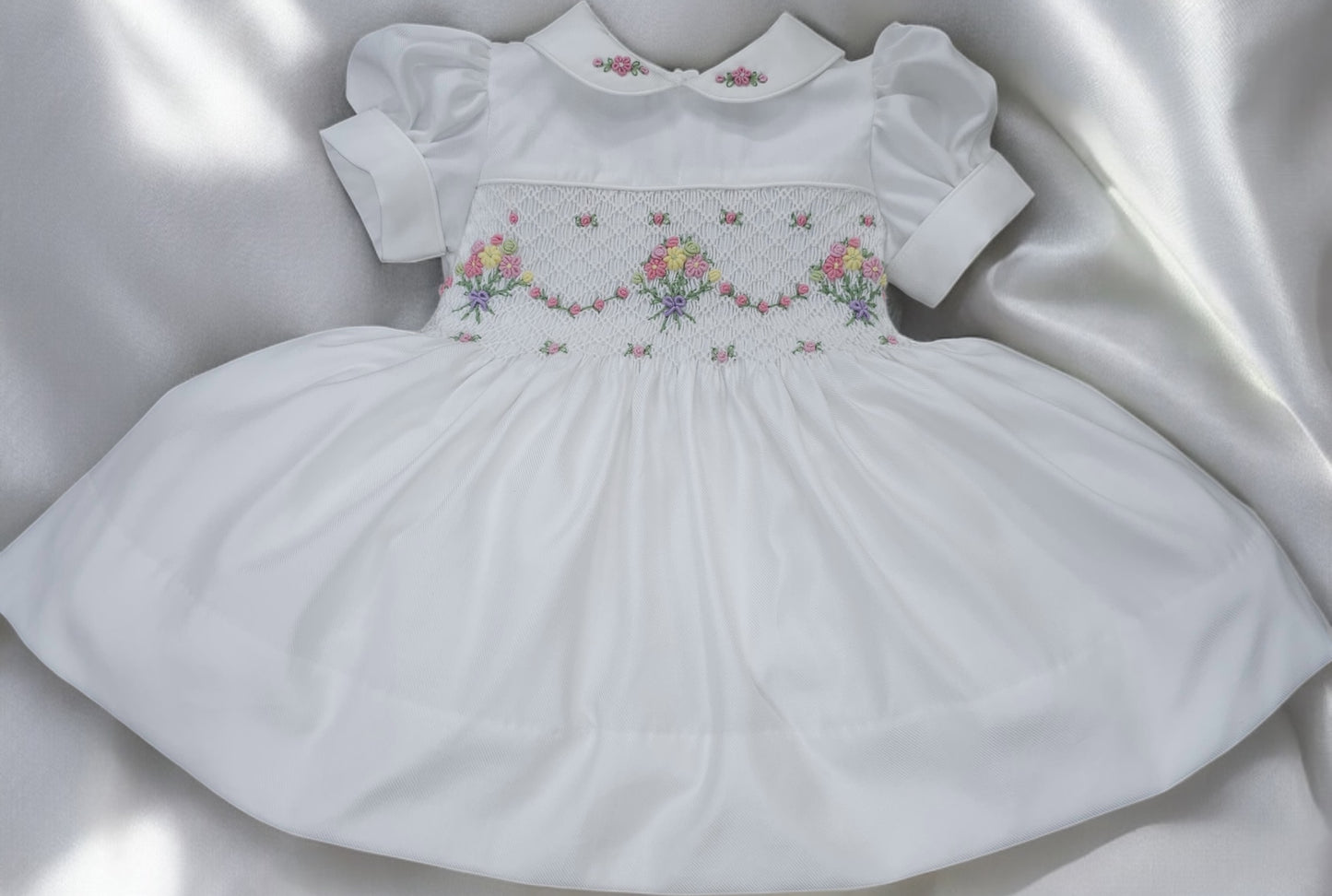 White smocked dress with embroidered flower baskets