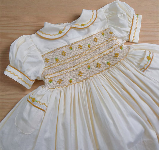 Cream dress with gold smocking & pockets ( got matching boys suit available )