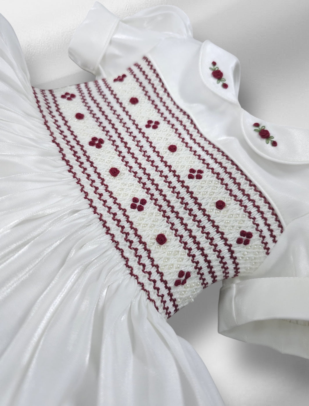 White shimmer with burgandy smocking and pearls