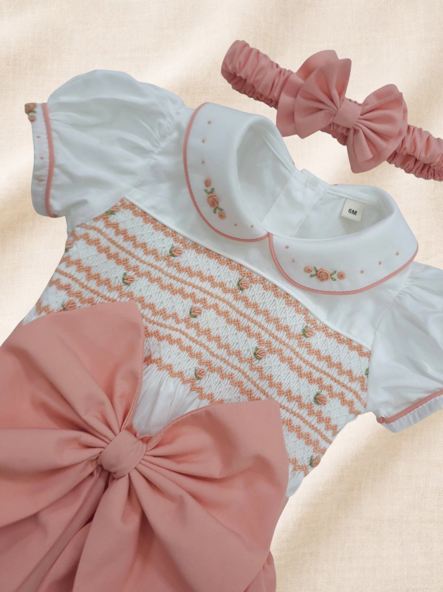 Peach coral hand smocked girls romper